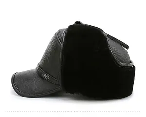 Detail of winter trapper hat featuring textured leather and thick faux fur ear flaps