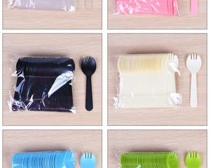 Detailed view of disposable plastic sporks in six vibrant colors on a wooden surface