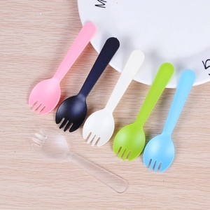 Pack of 6 colorful disposable plastic dessert forks and spoons on wooden table