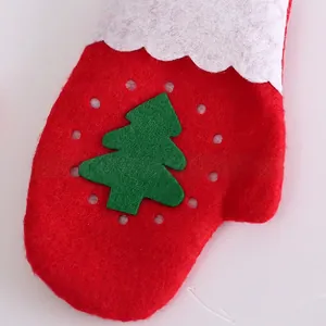 Close-up of red Christmas felt glove with white wavy trim and green tree patch