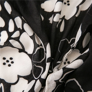 Close-up of black and white floral print on breathable cotton linen scarf fabric