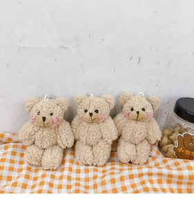 Detailed view of three plush bear keychains with soft faux fur and silver metal chains