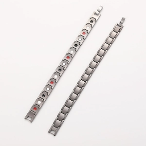 Detailed macro view of men's titanium magnetic therapy bracelet with multi-color inserts