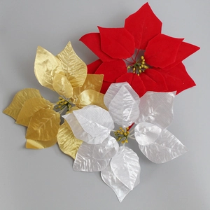 Close-up of red, gold and silver velvet artificial poinsettias with realistic textures