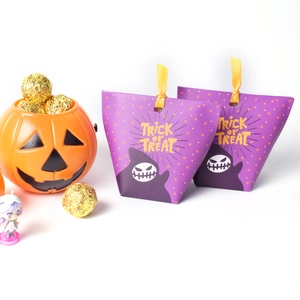 Detail of purple Halloween gift bag with cartoon ghosts and trick or treat text