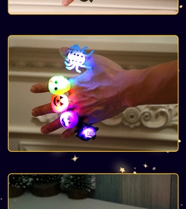Detail of multi-color LED Halloween rings featuring pumpkin and bat motifs on finger