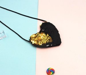 Detail of heart-shaped sequin crossbody bag with reversible black and gold flip sequins