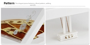 Detail of white piano music box showing internal gold gears and grey rose pattern