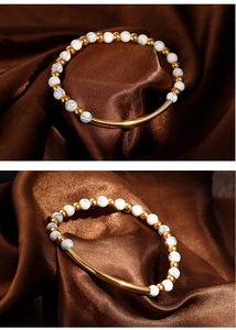 Close-up of white marble beads and polished gold curved tube on a luxury silk bracelet