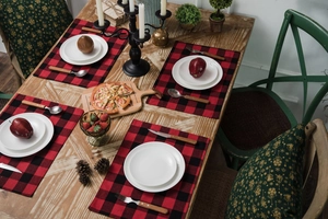 Close-up of red and black checkered cotton linen placemats on a festive wooden table