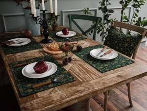 Festive dark green cotton linen placemats with gold snowflake print and holiday table decor