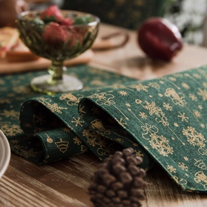 Christmas dark green table runner with gold snowflake and reindeer print on dining table