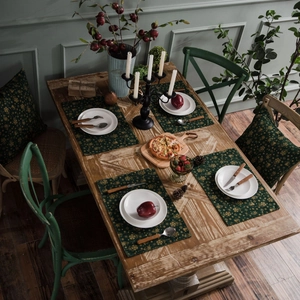 Dark green festive Christmas placemat set with gold snowflake patterns on cotton linen fabric