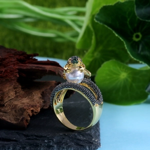 Macro detail of frog ring showing S925 hallmark, black pavé crystals and white pearl