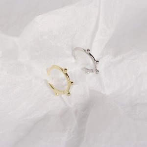 Detailed macro of gold and silver S925 sterling silver geometric hoop earrings