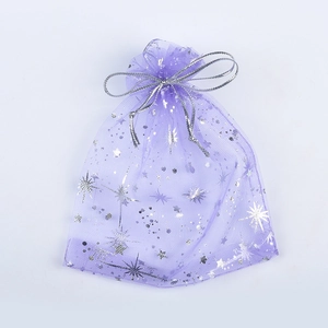 Purple organza gift bag with silver stars and dots patterns on a white background