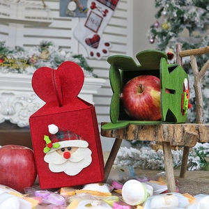 Christmas felt gift bags with Santa Claus design in a cozy holiday interior setting