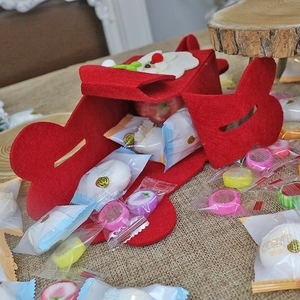 Foldable red felt Christmas gift bag featuring Santa Claus embroidery and heart-shaped handles