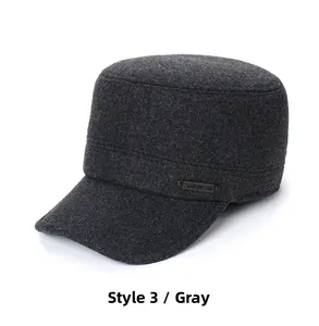 Detail of grey woolen military cadet hat with side metal decorative emblem and flat top