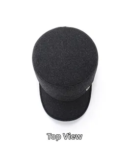 Top view of dark grey wool blend flat cap showing thick texture and circular crown