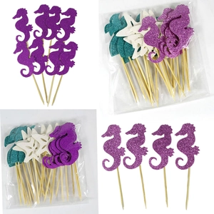 Detail of glitter mermaid cake toppers featuring seahorse star and tail with wooden sticks