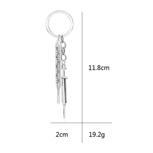 Medical silver alloy keychain with syringe and thermometer pendants on white background