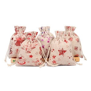 Assorted burlap Christmas drawstring gift bags with Santa Claus and reindeer patterns