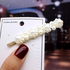 Detailed macro view of trendy pearl hair clip set with elegant gradient faux pearls