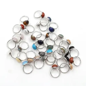 Adjustable silver rings with colorful natural crystal stone beads on white background