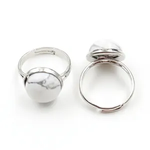 Detail of adjustable silver ring with marble-patterned white round gemstone