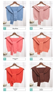 Detail view of knitted collar scarves in six colors including blue, pink, and orange