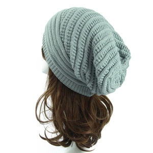 Detail of light grey knit beanie with vertical striped texture and slouchy back view