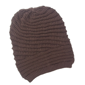 Detailed view of dark brown knitted beanie showing thick textured yarn and weave pattern