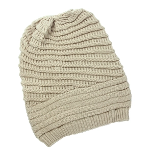 Close-up of beige knit beanie texture showing detailed high-quality fiber weaving pattern
