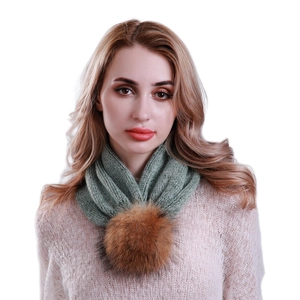 Women's green knit infinity scarf with brown fur pom-pom shown on fashion model