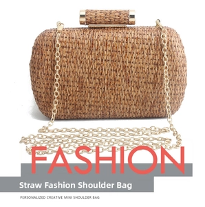 Detail of hand-woven straw texture with a gold metal push-lock on a bohemian clutch