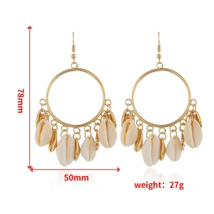 Detailed view of bohemian gold hoop earrings with natural cowrie shells and size specs