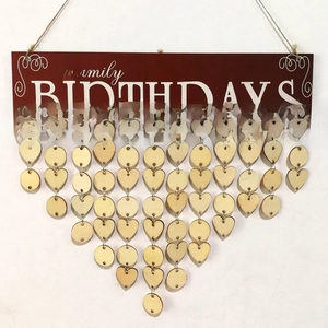 Detail of wooden family birthday calendar with hanging heart and round heart tags
