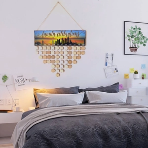 Detail of wooden family celebration calendar with month discs on a cozy bedroom wall