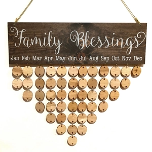 Detail of wooden family birthday calendar plaque with hanging round wood tags