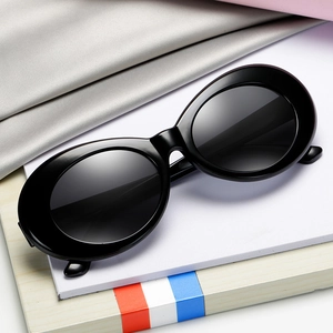 Classic retro oval sunglasses with a black frame and dark lenses shown from a 45-degree angle