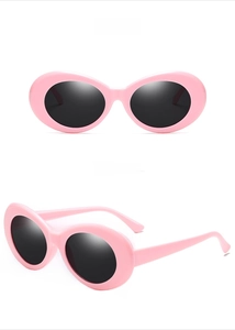 Detailed view of pink oval retro sunglasses with gray lenses in Clout Goggles Y2K style