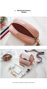 Pink lychee leather crossbody bag with cherry detail showing interior storage capacity
