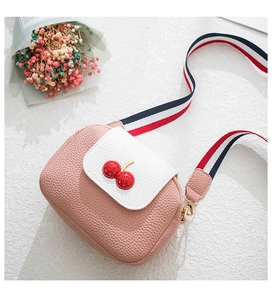 Close-up of pink cherry crossbody bag with pebble grain leather and striped strap