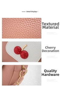 Detail of pink pebbled leather with a crystal-encrusted cherry and gold hardware