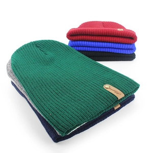 Unisex winter knit beanie set in multiple colors with ribbed texture and leather logo patch