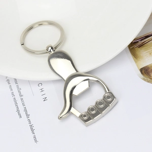 Silver thumb-shaped metal keychain with integrated bottle opener on a stylish background
