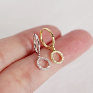 Macro shot of silver and gold plated s925 silver hoop earrings with diamond accents