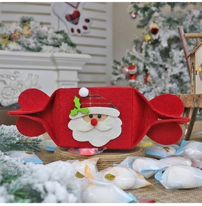 Detailed close-up of a red felt Christmas candy bag with 3D Santa Claus figure