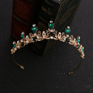 Vintage golden alloy crown with emerald crystals and sparkling diamonds for parties